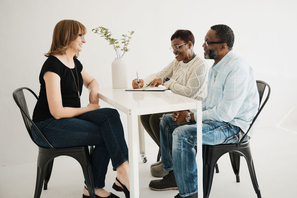 Jill Mueller at a table with two people